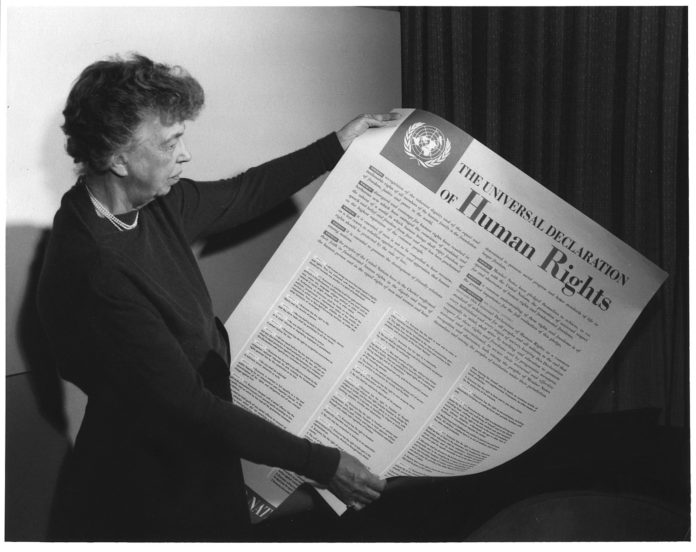 Eleanor Roosevelt holding poster of the Universal Declaration of Human Rights (in English), Lake Success, New York. November 1949.