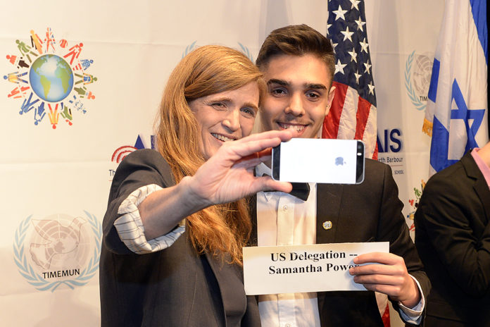 Samantha Power takes a selfie with a student who is holding a name tag that reads 