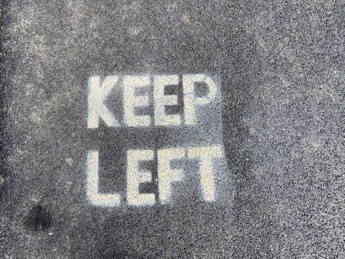 A footpath with the words 'keep left' spraypainted